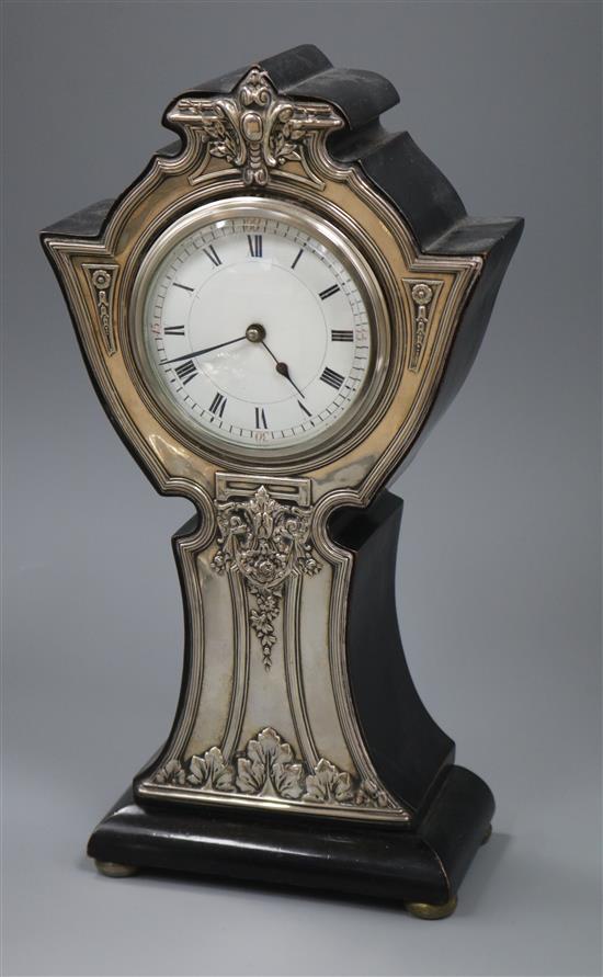 A George V Art Nouveau silver mounted ebonised mantle timepiece, G.E Walton & Co Ltd, Birmingham, 1910, 32cm.